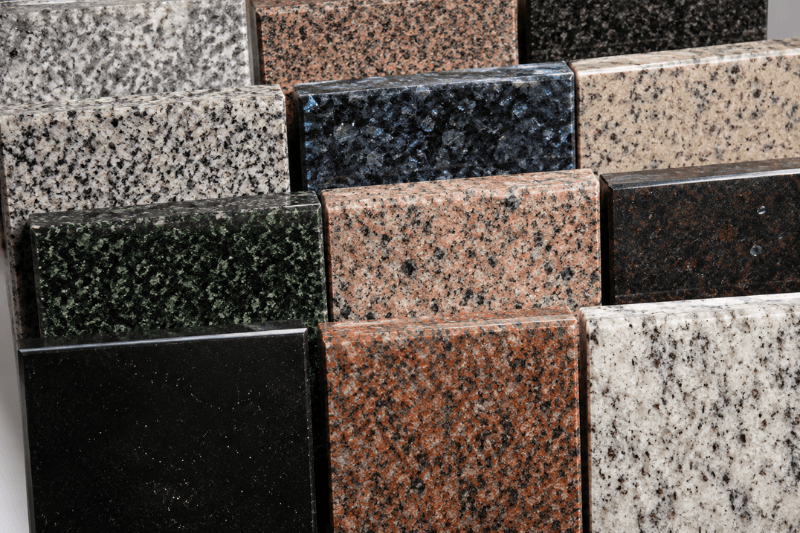 Polished granite sample tiles showing black, gray, green, blue, pink, red, and cream color variations